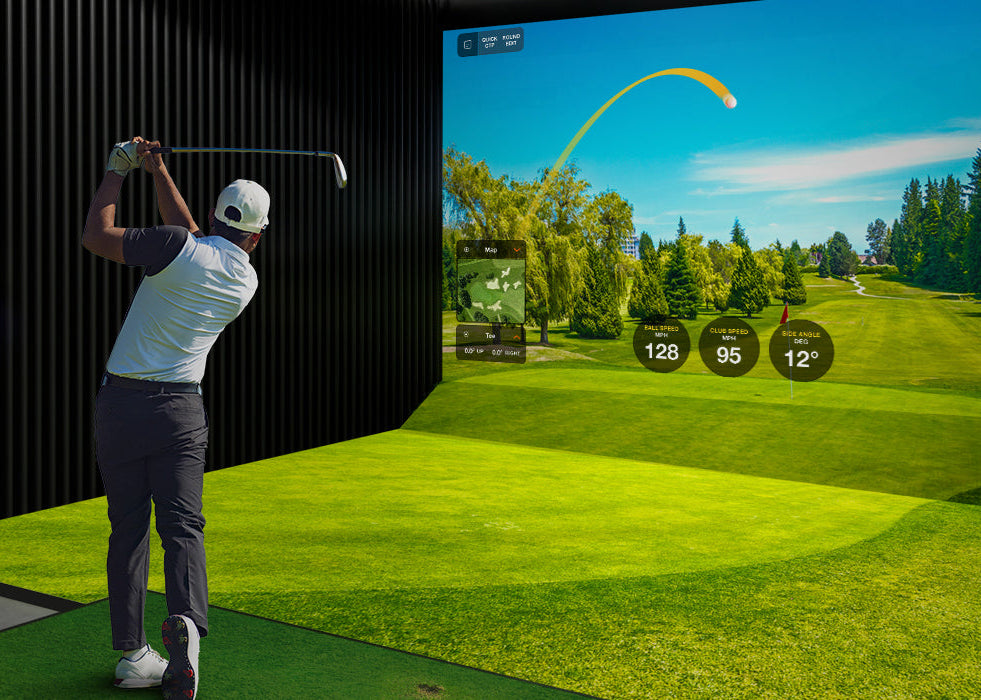 Person playing golf simulator game in a dark room with screen displaying golf course - Sim Nation Golf