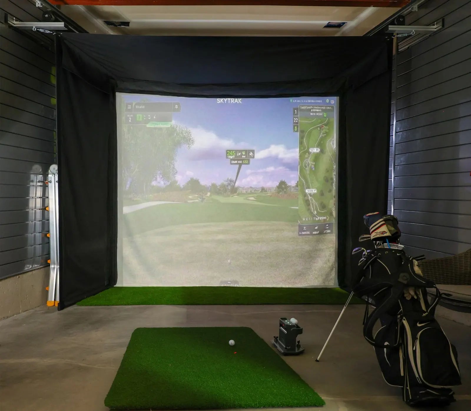 Indoor golf simulator setup with Retractable Golf Simulator Enclosure